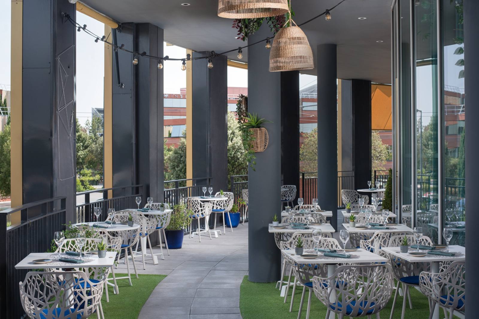 The covered terrace, tables set among the plants